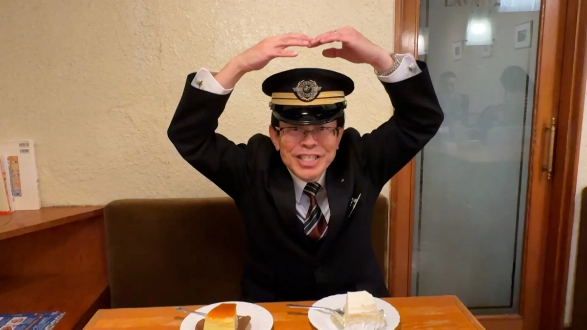 鉄道員の制服を着た男性とケーキ