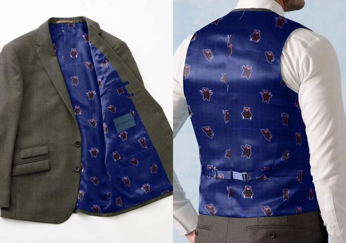 スーツジャケットとベストの裏地に、遊び心のある可愛らしいクマ柄がデザインされている様子を捉えた画像です。フォーマルな装いの中に個性を加えるディテールが特徴です。