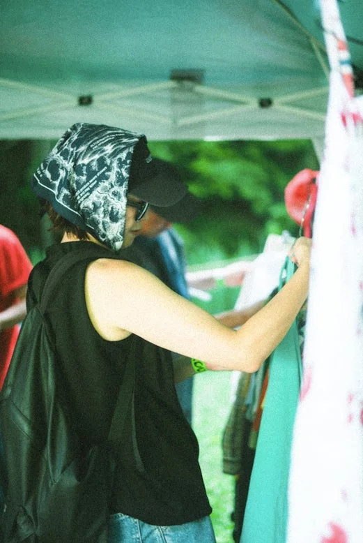 屋外で衣類を物色する人々