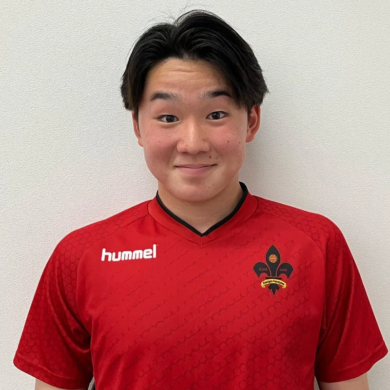 赤いスポーツユニフォームを着た竹松駿選手